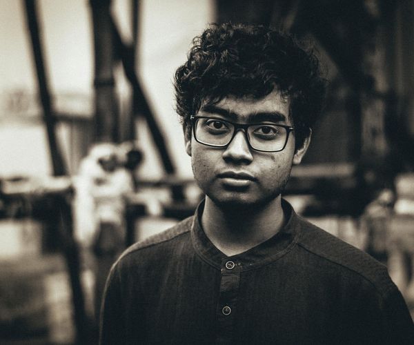 Man looking into the distance with a clear, focused gaze in a natural setting.